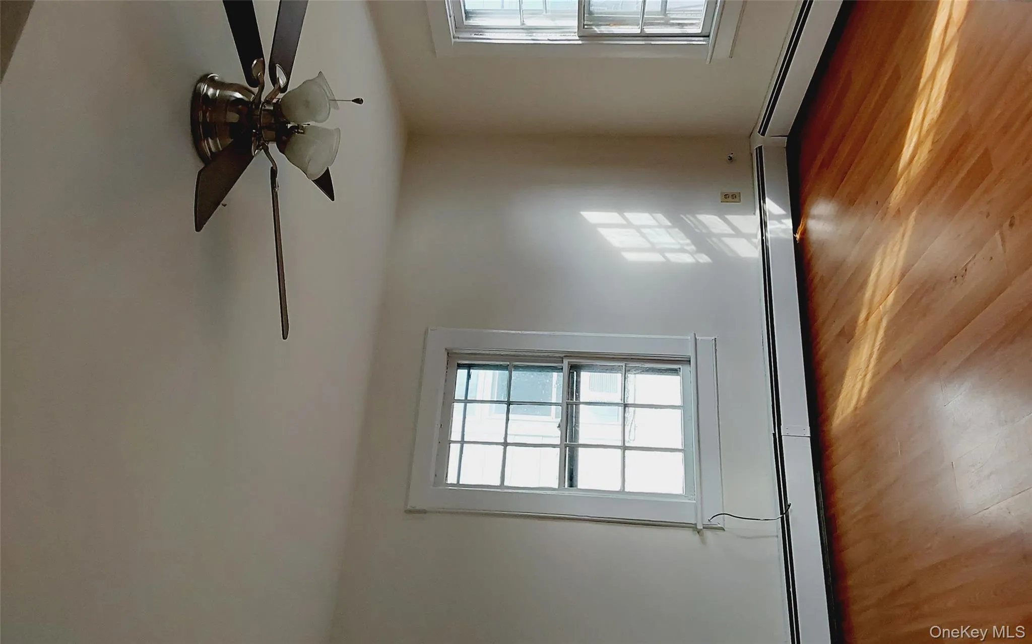 Spare room featuring light wood-style flooring, a baseboard heating unit, and ceiling fan Spare room featuring light wood-style flooring, a baseboard heating unit, and ceiling fan