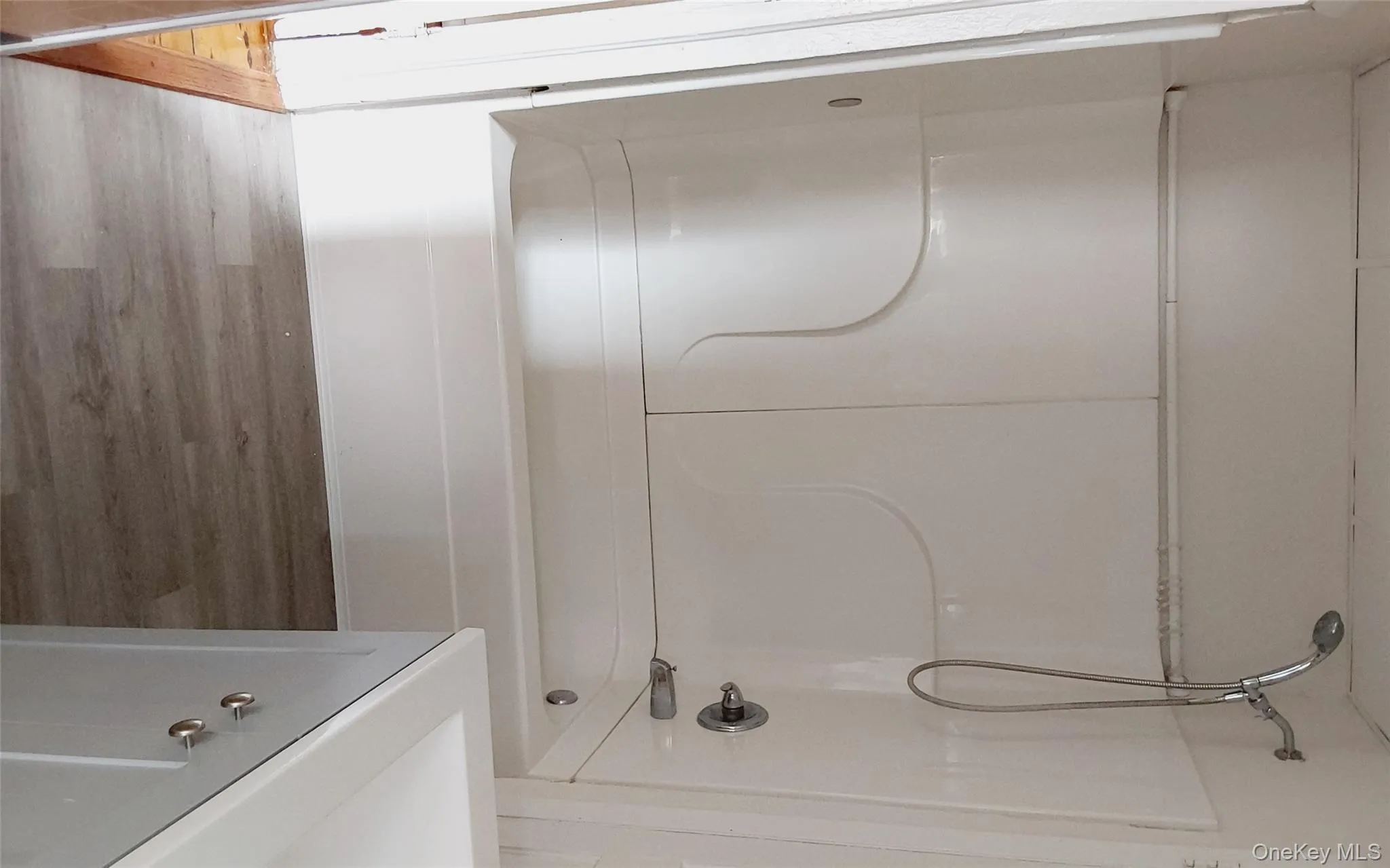 Full bathroom with tub / shower combination, vanity, and wood finished floors Full bathroom with tub / shower combination, vanity, and wood finished floors