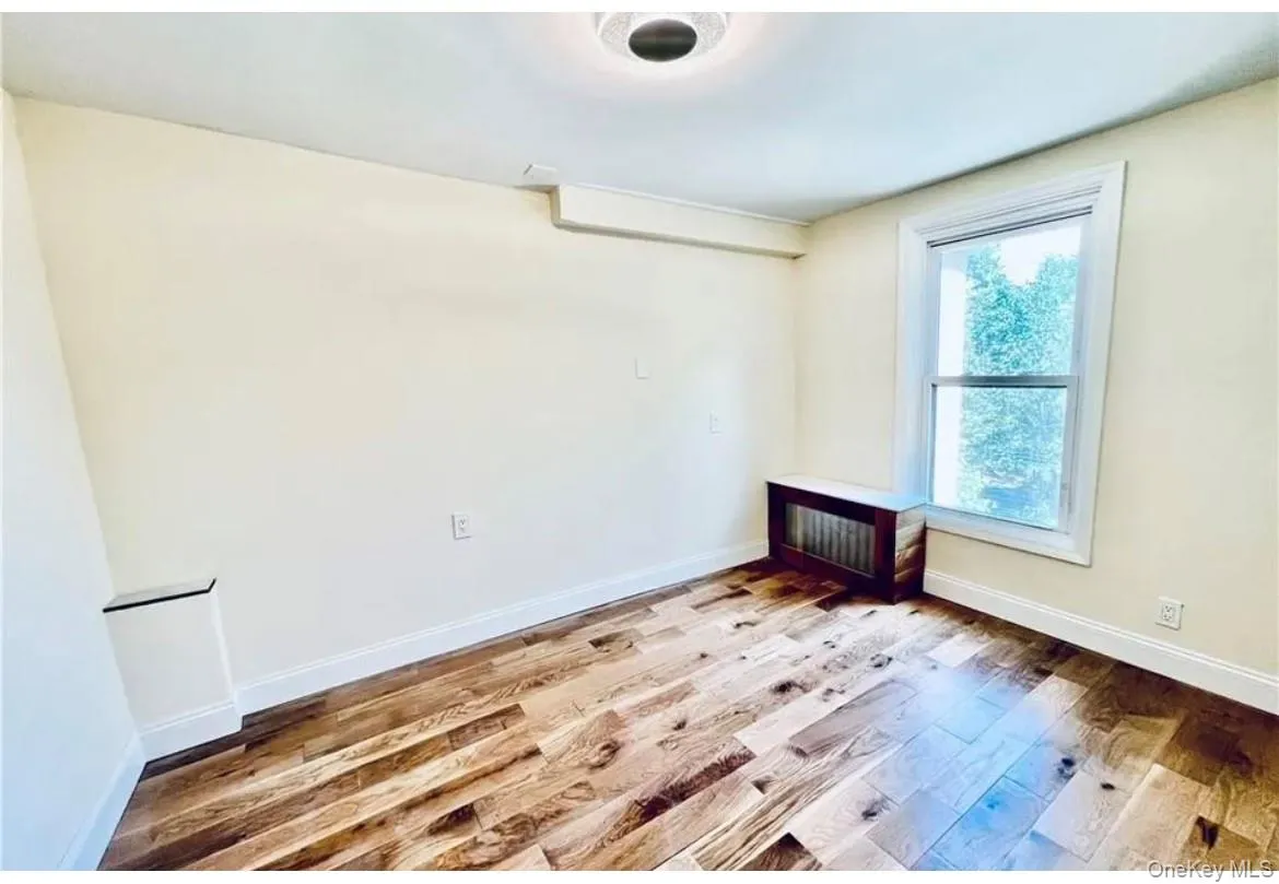 Empty room with baseboards and wood finished floors Empty room with baseboards and wood finished floors