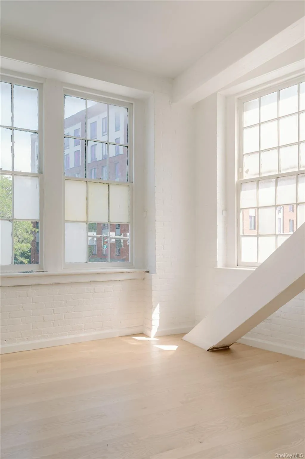 Unfurnished room with wood finished floors and baseboards Unfurnished room with wood finished floors and baseboards