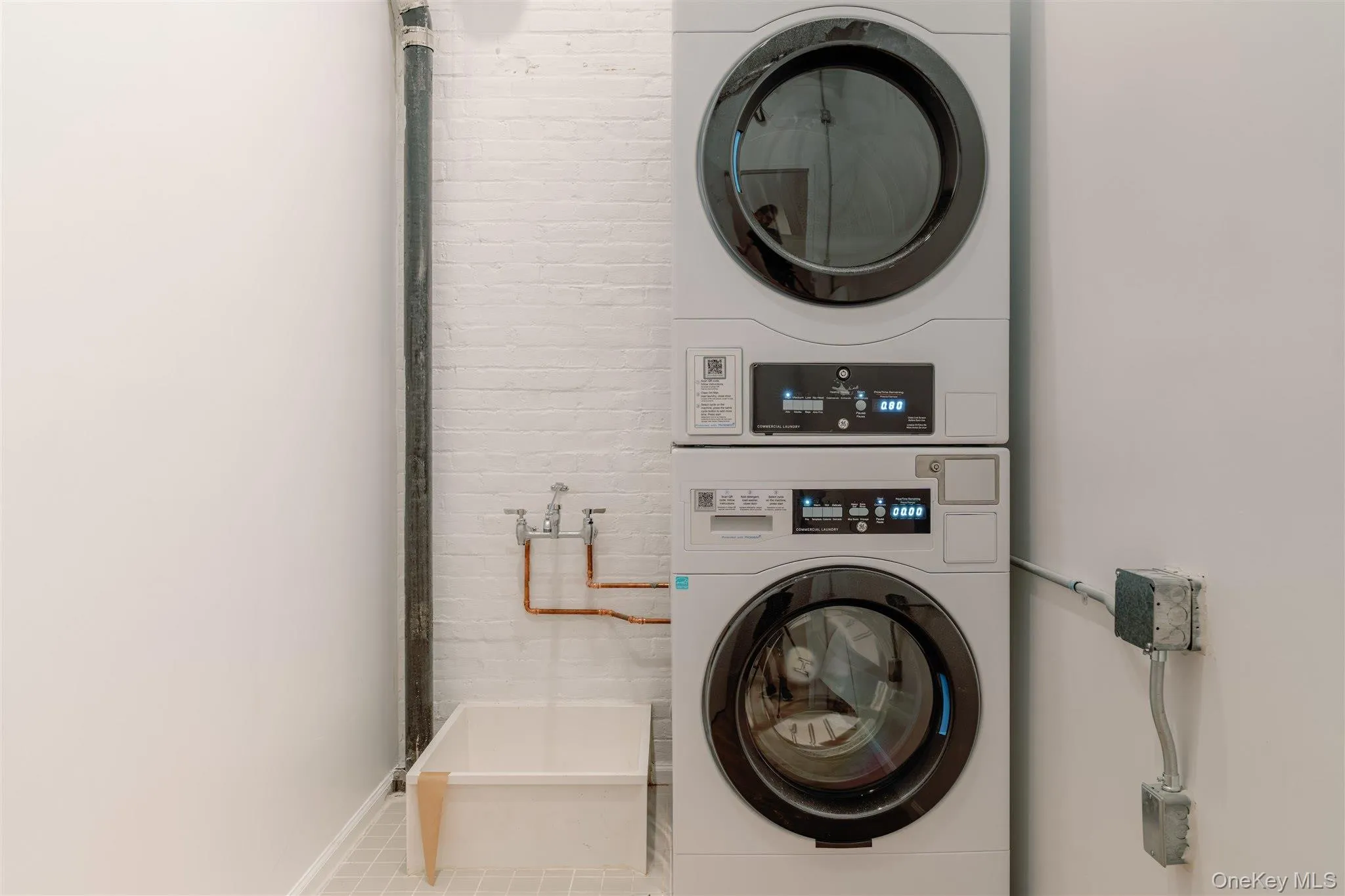 Washroom featuring stacked washer / dryer Washroom featuring stacked washer / dryer