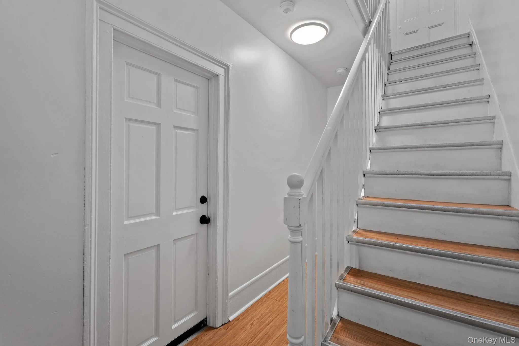 Stairs with wood finished floors and baseboards Stairs with wood finished floors and baseboards