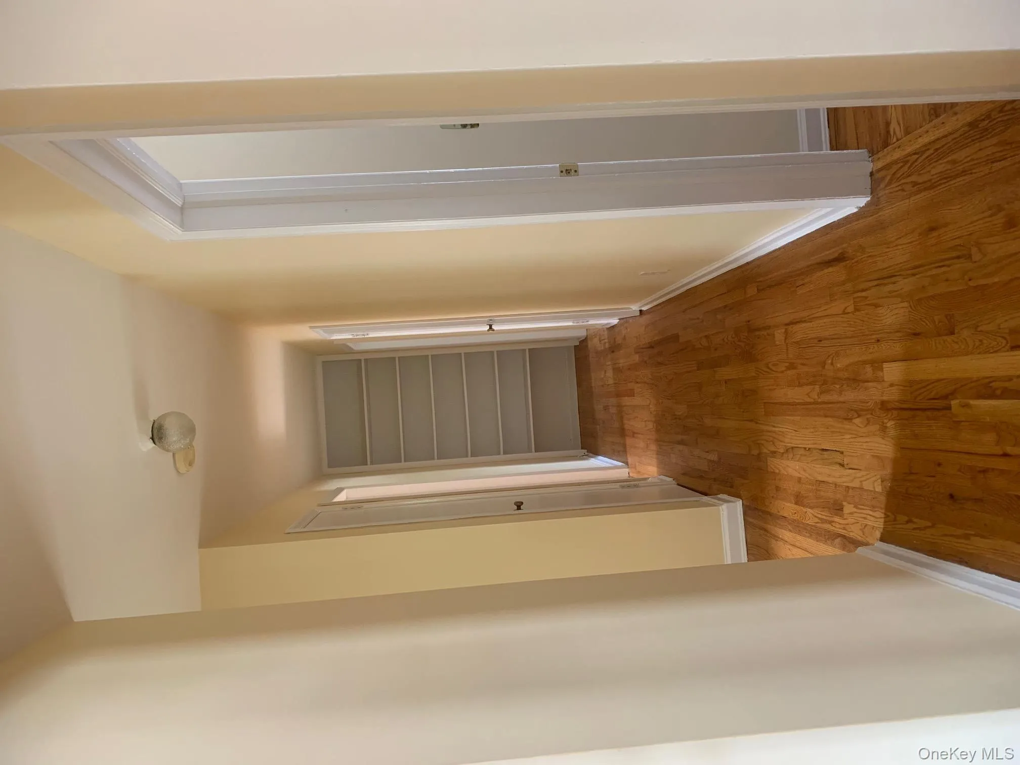 Hallway featuring light wood-type flooring and baseboards Hallway featuring light wood-type flooring and baseboards