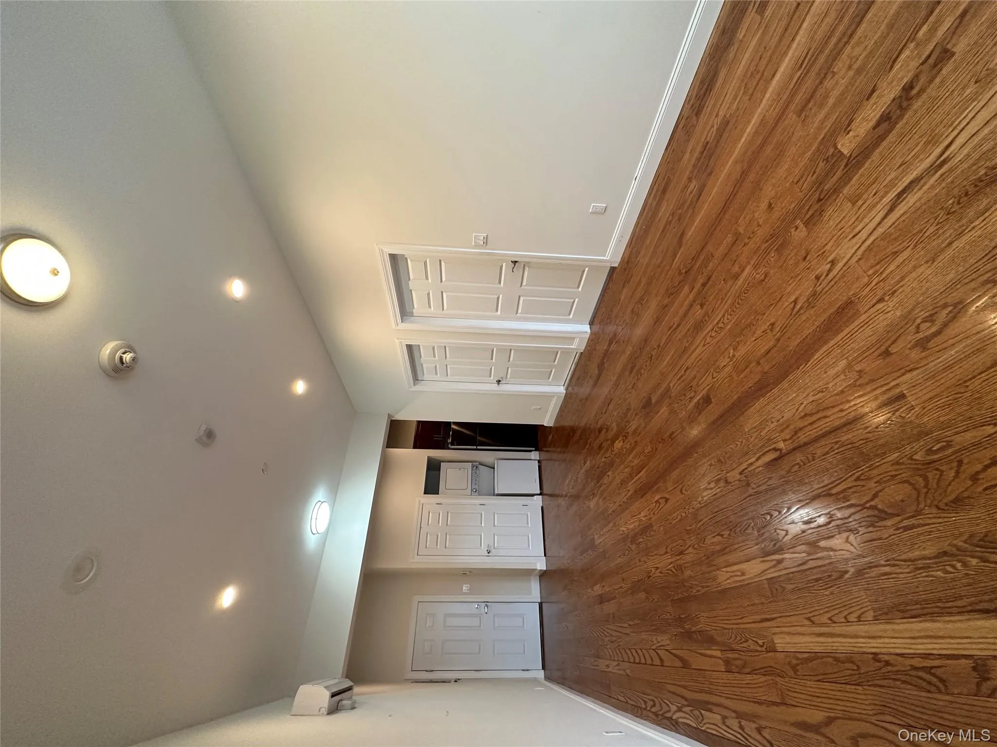 Empty room with dark wood-type flooring and recessed lighting Empty room with dark wood-type flooring and recessed lighting