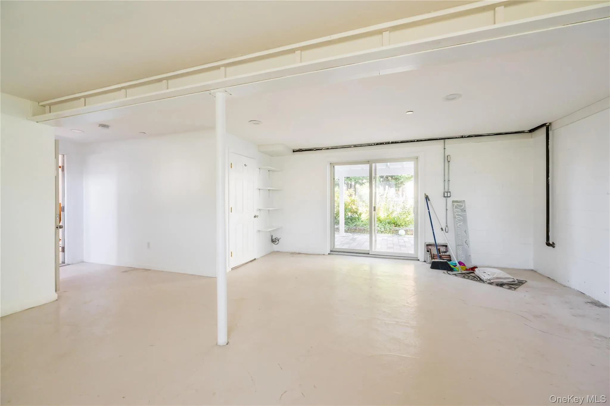Spare room featuring concrete floors Spare room featuring concrete floors