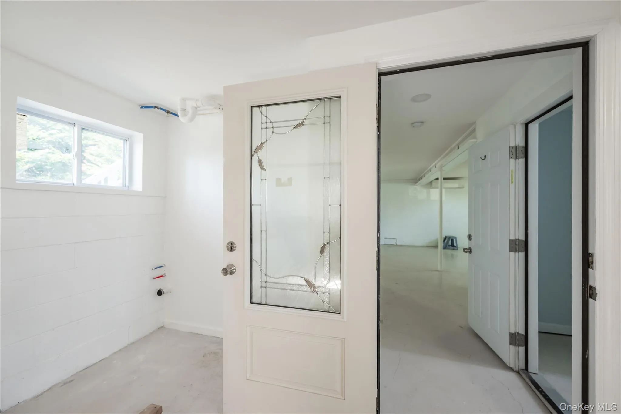 Doorway to outside featuring concrete floors Doorway to outside featuring concrete floors