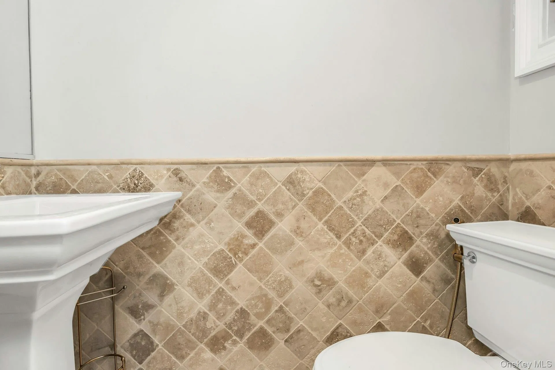 Bathroom with tile walls and wainscoting Bathroom with tile walls and wainscoting