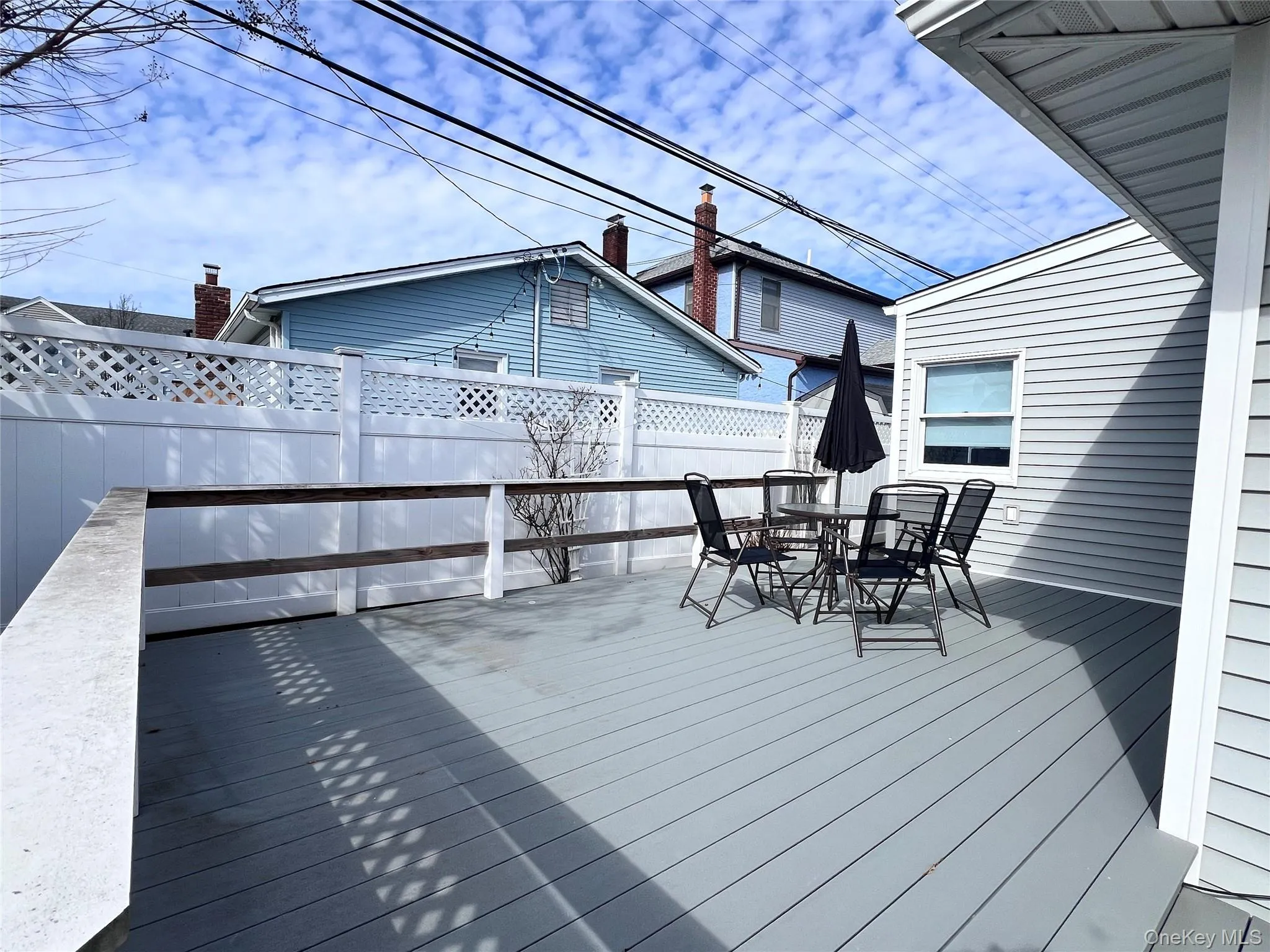 Wooden terrace featuring outdoor dining area and fence Wooden terrace featuring outdoor dining area and fence