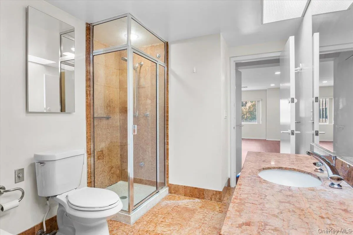Bathroom featuring vanity and a shower stall Bathroom featuring vanity and a shower stall
