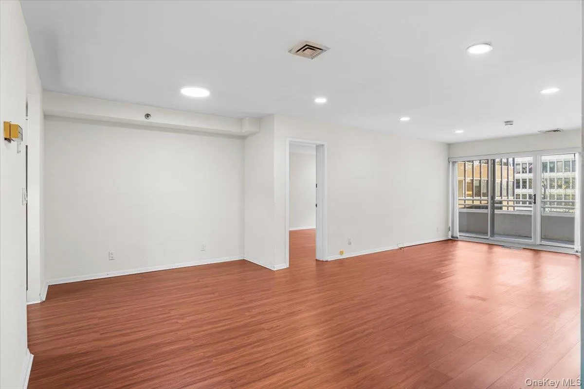 Spare room with wood finished floors and recessed lighting Spare room with wood finished floors and recessed lighting