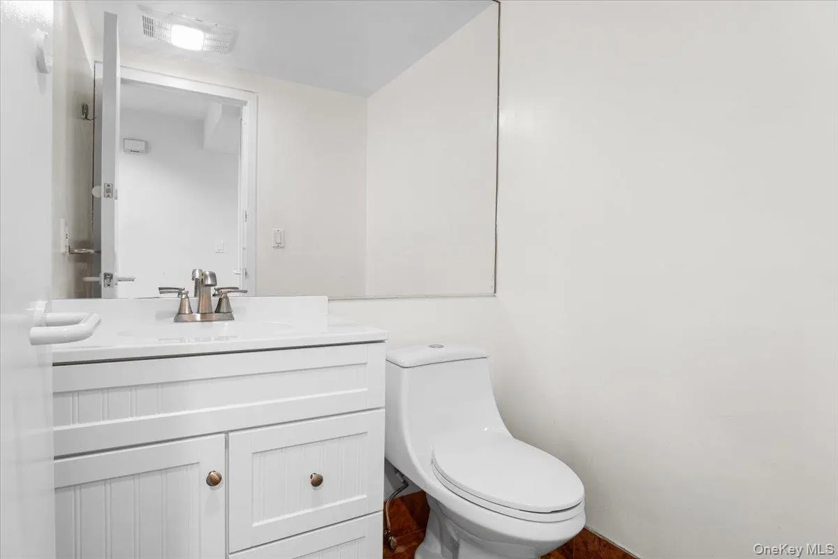 Half bathroom with vanity and toilet Half bathroom with vanity and toilet