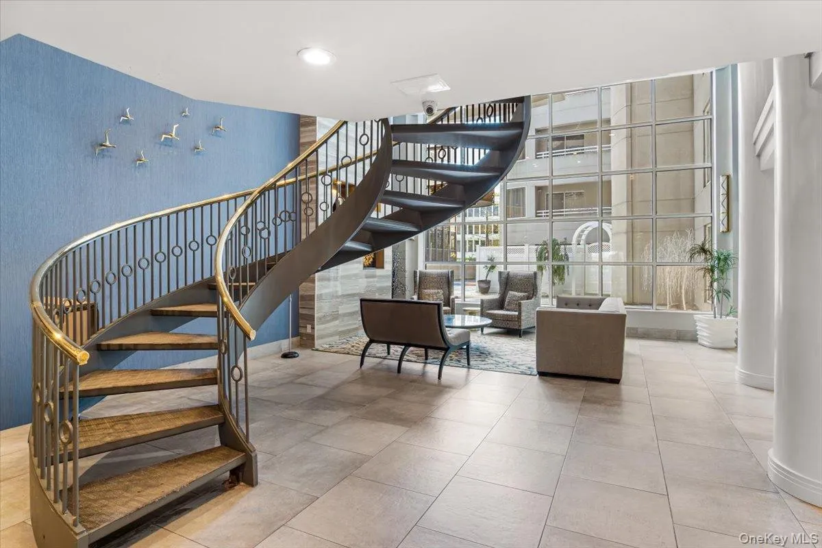 Lobby with stairs and floor to ceiling windows Lobby with stairs and floor to ceiling windows