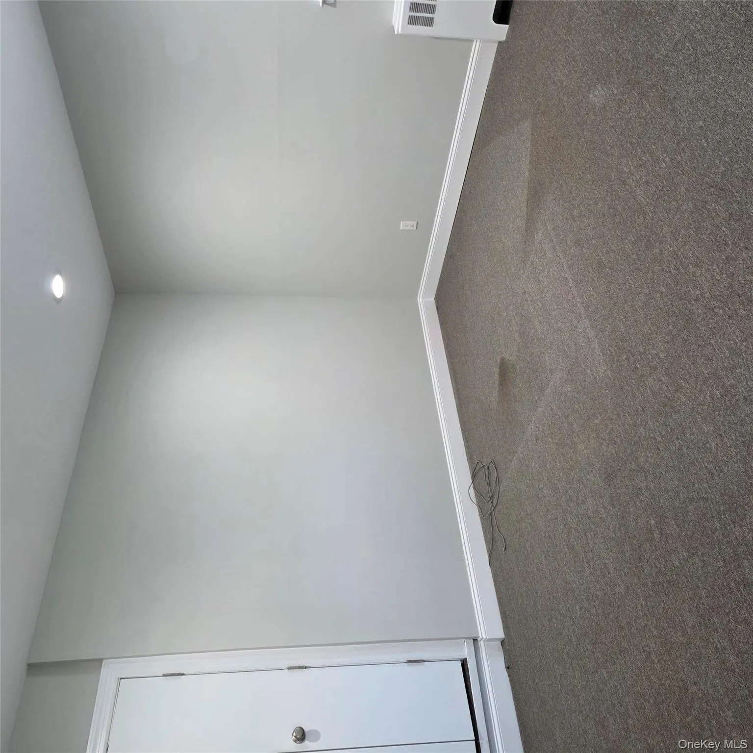 Spare room with dark carpet, recessed lighting, and radiator Spare room with dark carpet, recessed lighting, and radiator