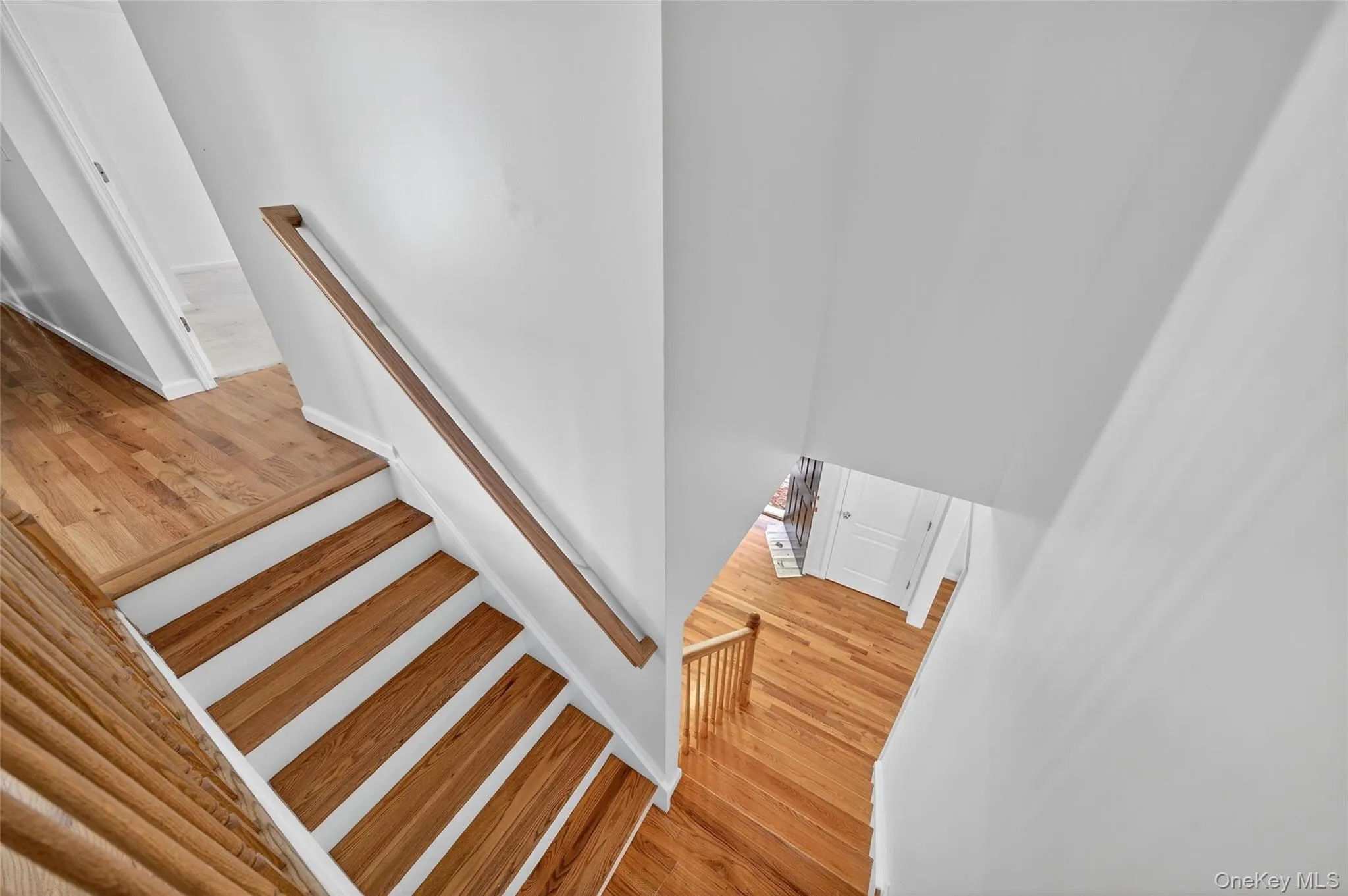 Stairs featuring wood finished floors Stairs featuring wood finished floors