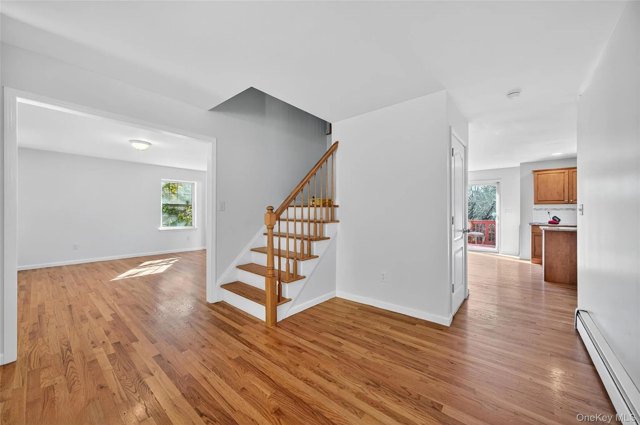 Stairs with a baseboard radiator and wood finished floors Stairs with a baseboard radiator and wood finished floors