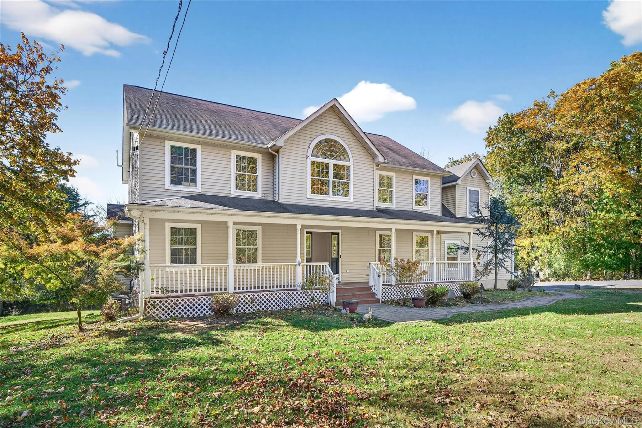 View of front of home with covered porch and a front lawn View of front of home with covered porch and a front lawn