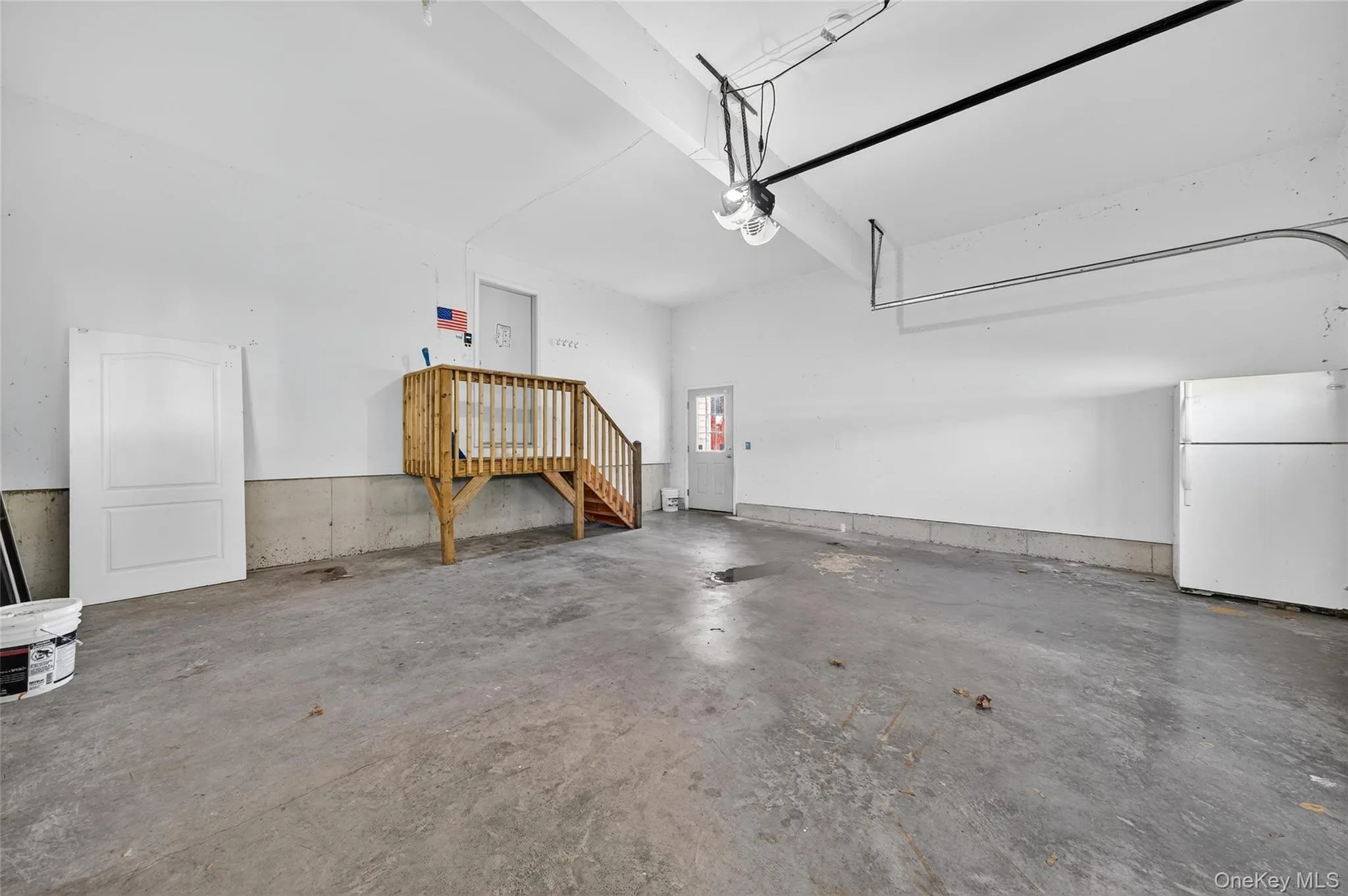 Garage with freestanding refrigerator Garage with freestanding refrigerator