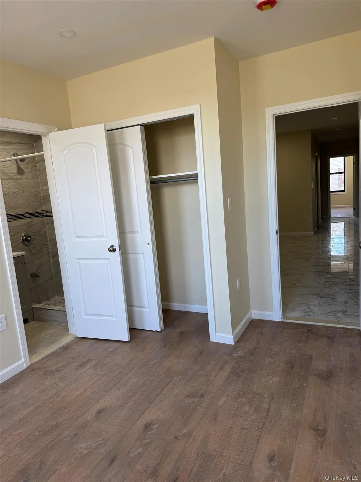 Unfurnished bedroom featuring a closet and dark wood-type flooring Unfurnished bedroom featuring a closet and dark wood-type flooring