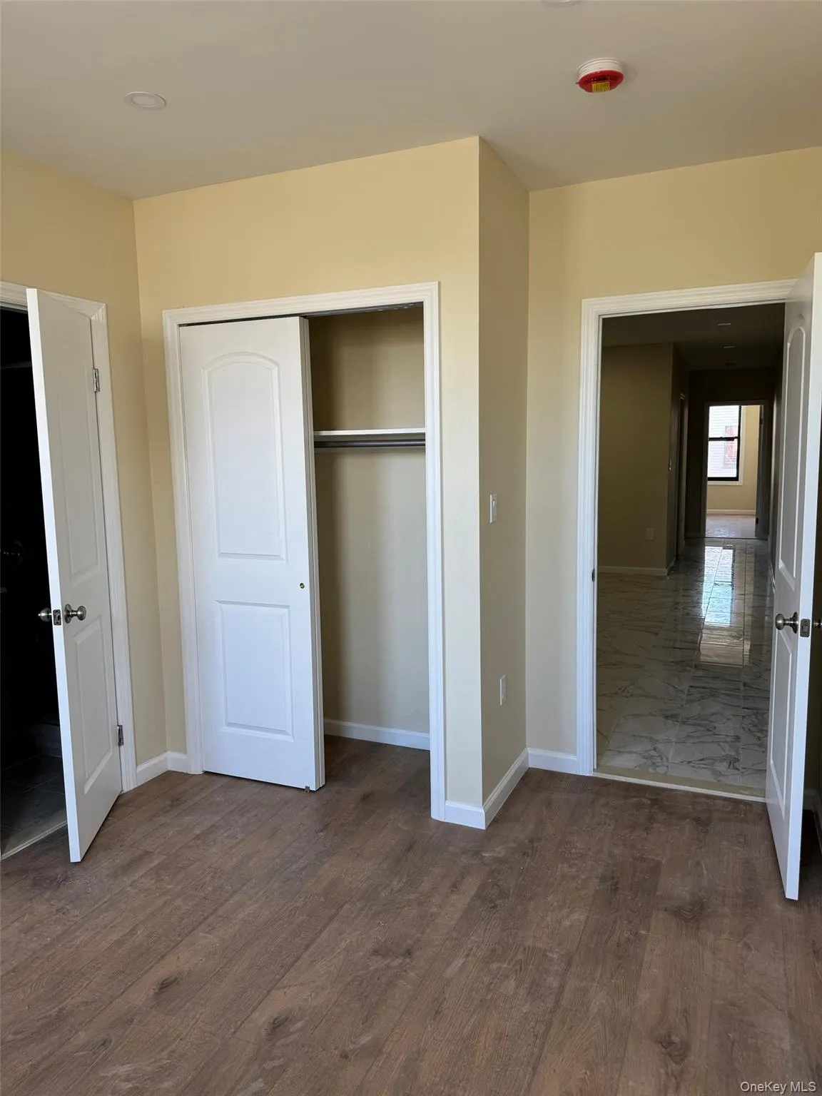Unfurnished bedroom with a closet and dark wood-type flooring Unfurnished bedroom with a closet and dark wood-type flooring