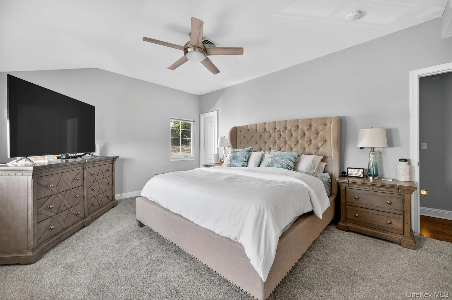 Carpeted bedroom with a ceiling fan and baseboards Carpeted bedroom with a ceiling fan and baseboards