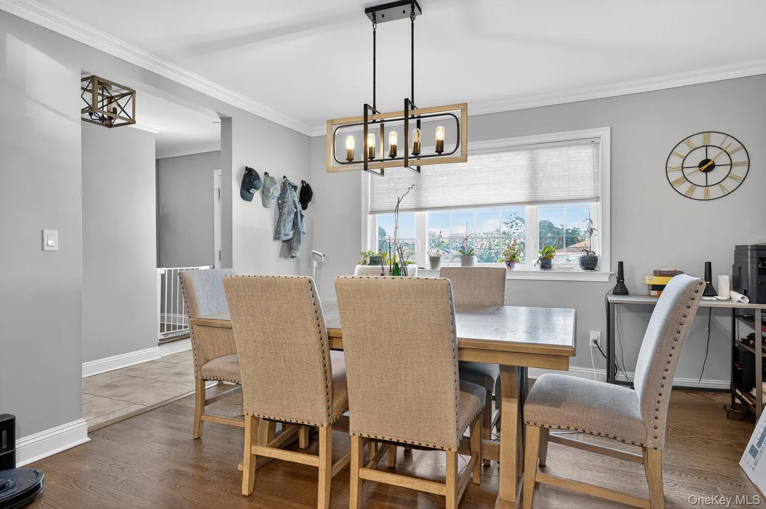 Dining area featuring crown molding, a chandelier, and dark wood-style flooring Dining area featuring crown molding, a chandelier, and dark wood-style flooring