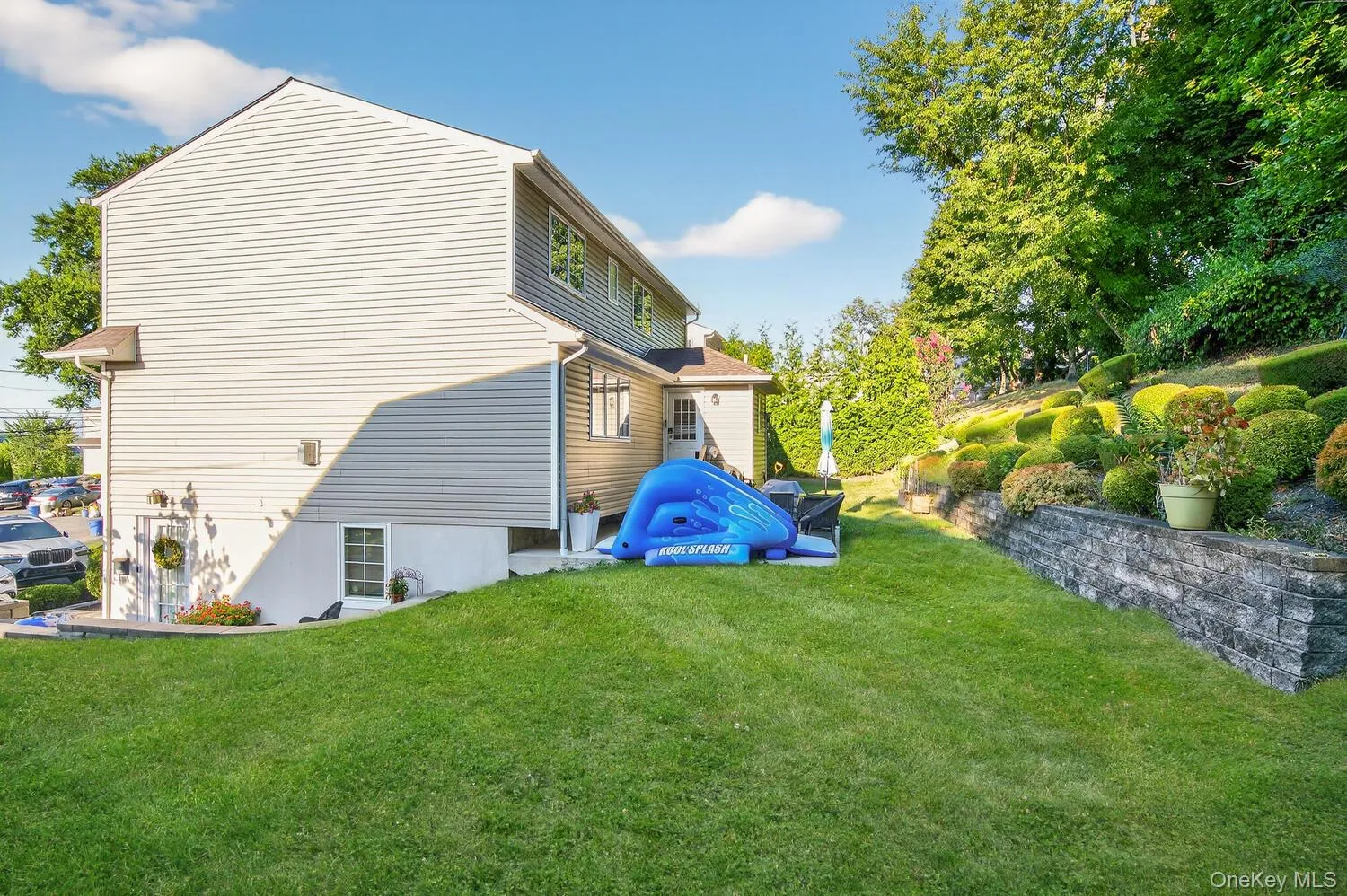 View of property exterior featuring a yard View of property exterior featuring a yard