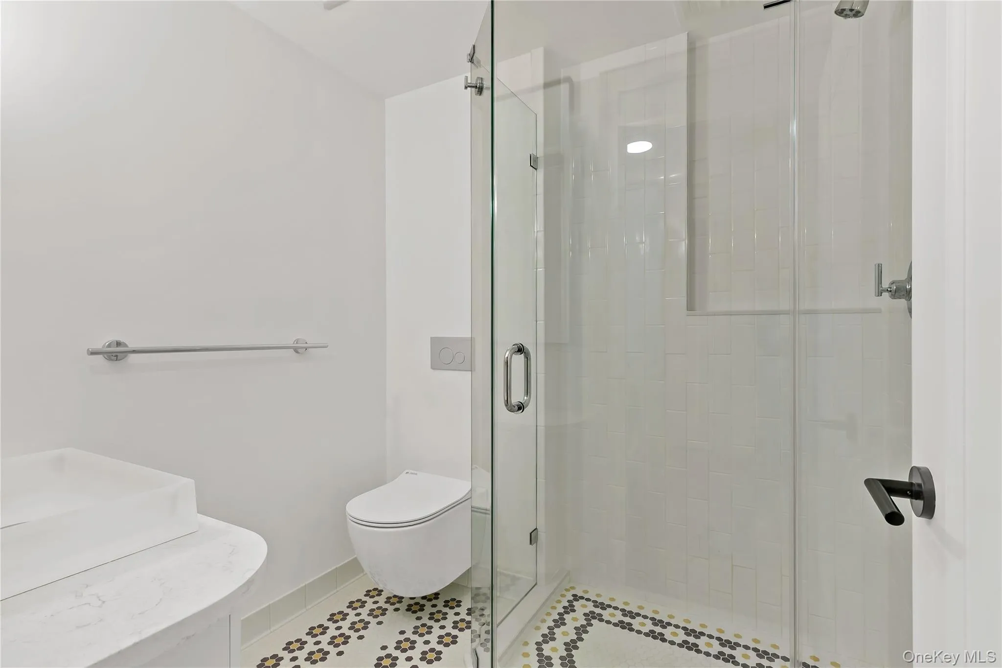 Bathroom with a stall shower, tile patterned floors, and vanity Bathroom with a stall shower, tile patterned floors, and vanity