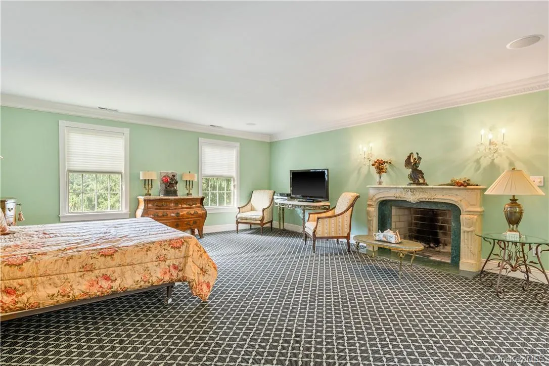Gracious and spacious primary bedroom with fireplace Gracious and spacious primary bedroom with fireplace