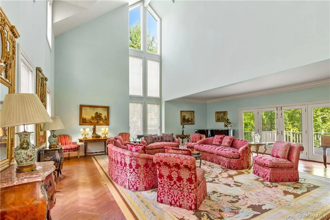 Stunning Great room with soaring ceilings, herringbone wood floors, doors to deck Stunning Great room with soaring ceilings, herringbone wood floors, doors to deck