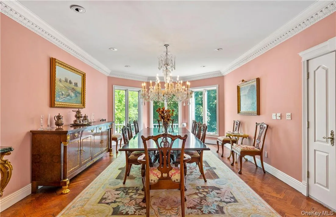 Spacious Dining Room with lovely moldings, herringbone floors and windows overlooking the property Spacious Dining Room with lovely moldings, herringbone floors and windows overlooking the property
