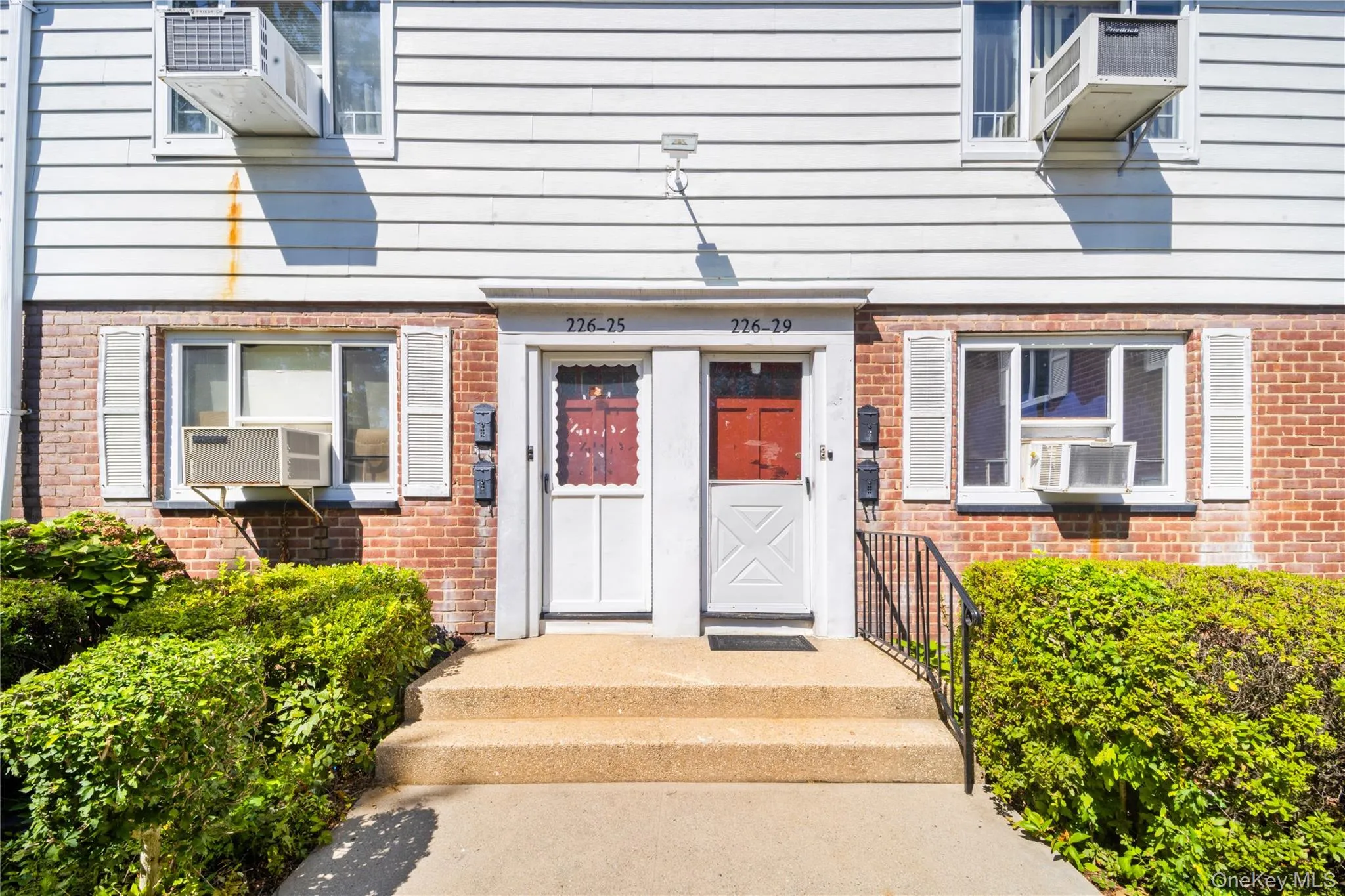 Doorway to property featuring brick siding and cooling unit Doorway to property featuring brick siding and cooling unit