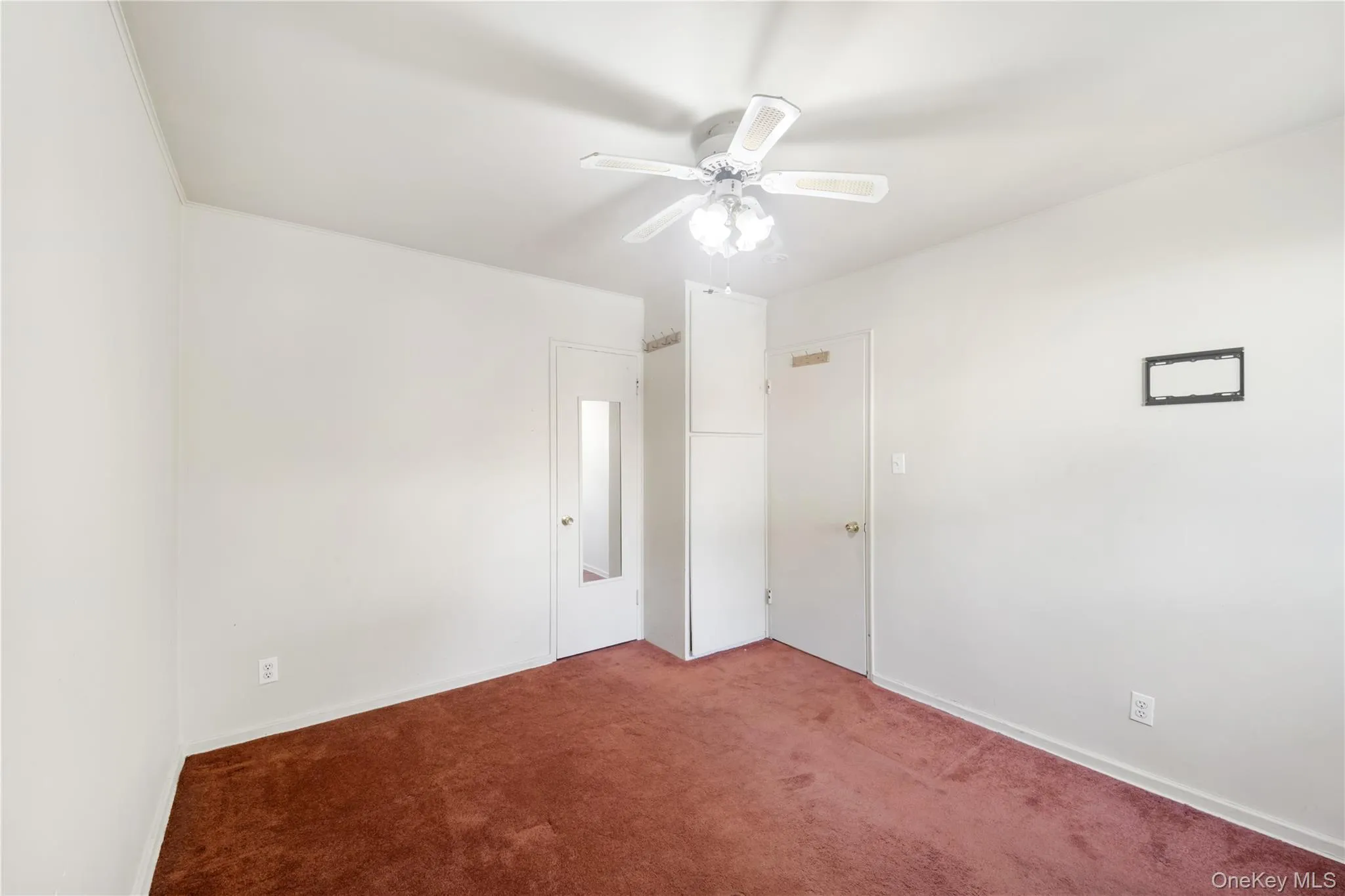 Unfurnished bedroom featuring carpet floors and a ceiling fan Unfurnished bedroom featuring carpet floors and a ceiling fan