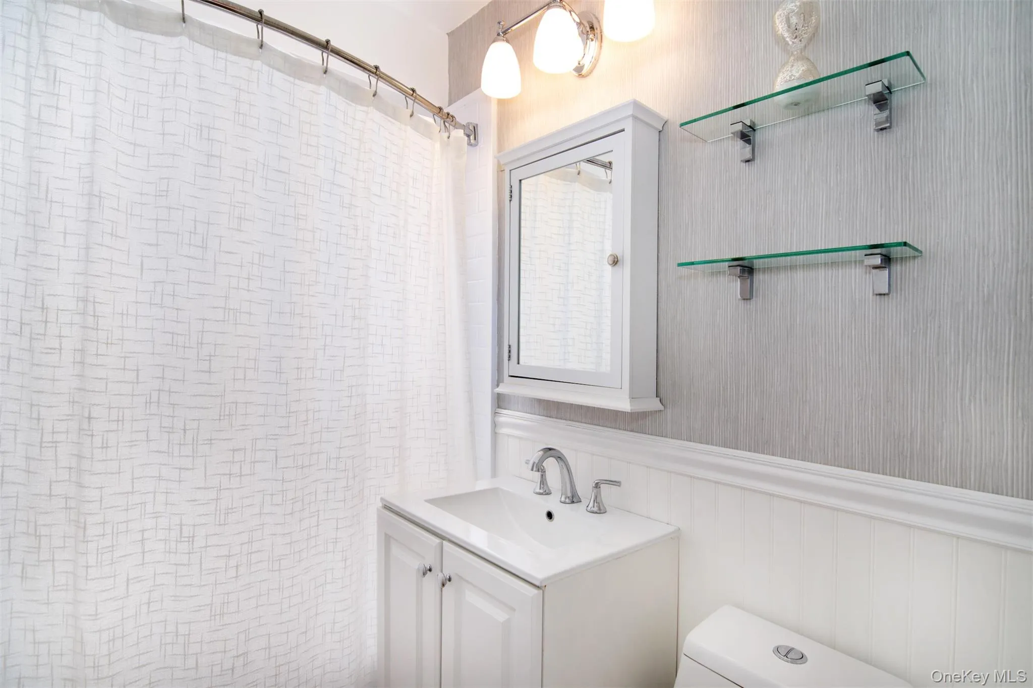 Tastefully redone bath with lovely wainscoting Tastefully redone bath with lovely wainscoting