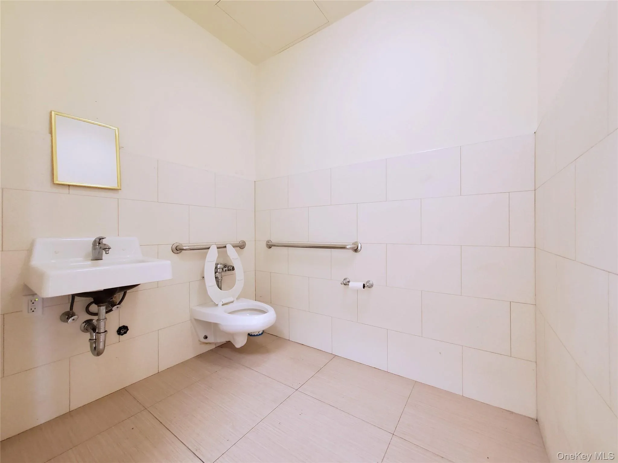 Bathroom with tile walls and tile patterned floors Bathroom with tile walls and tile patterned floors