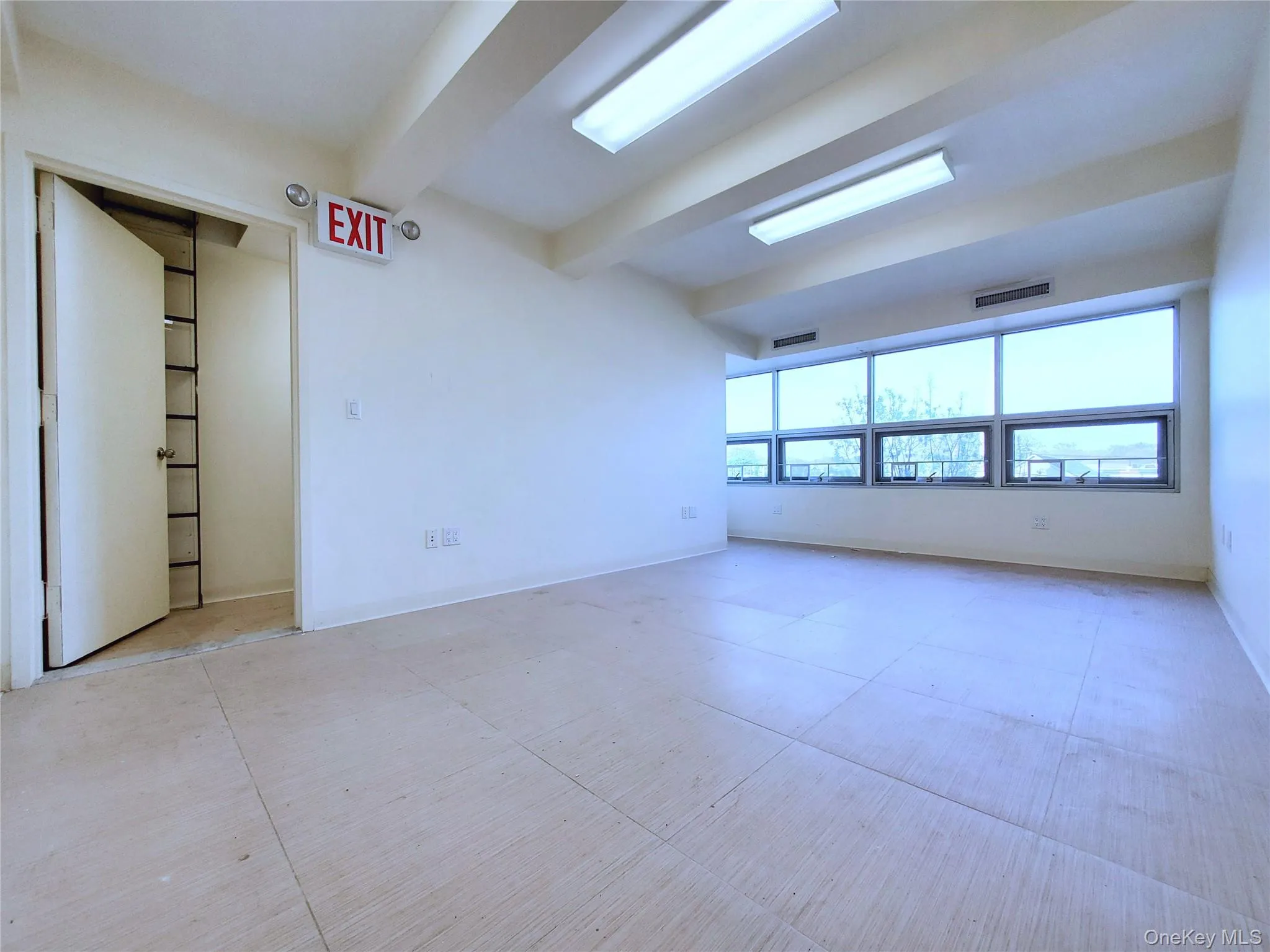 Unfurnished room featuring beam ceiling and baseboards Unfurnished room featuring beam ceiling and baseboards