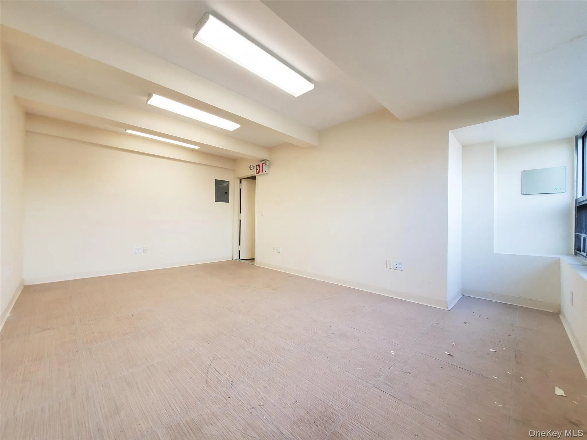 Spare room with baseboards and electric panel Spare room with baseboards and electric panel