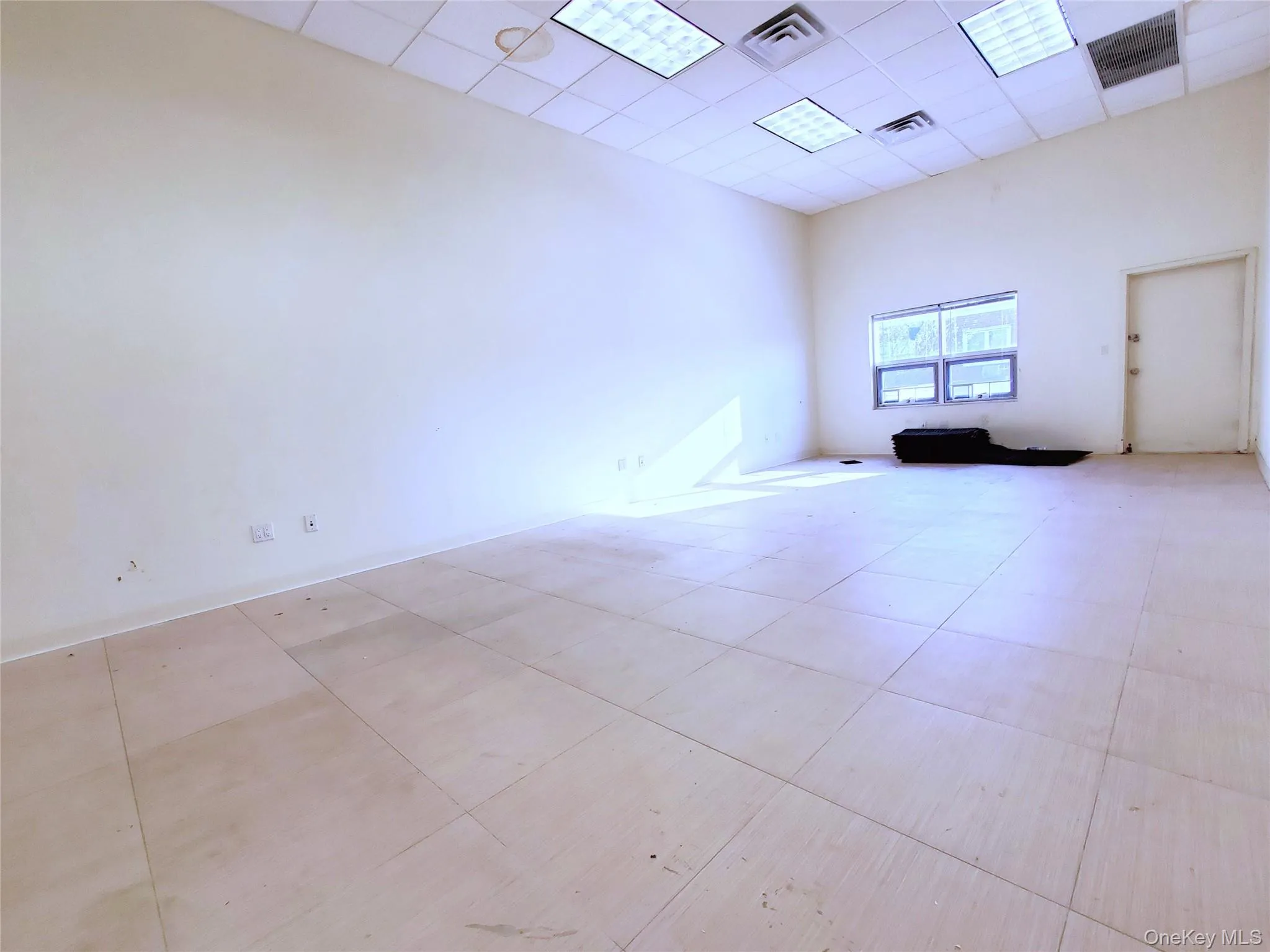 Unfurnished room with a drop ceiling and a high ceiling Unfurnished room with a drop ceiling and a high ceiling