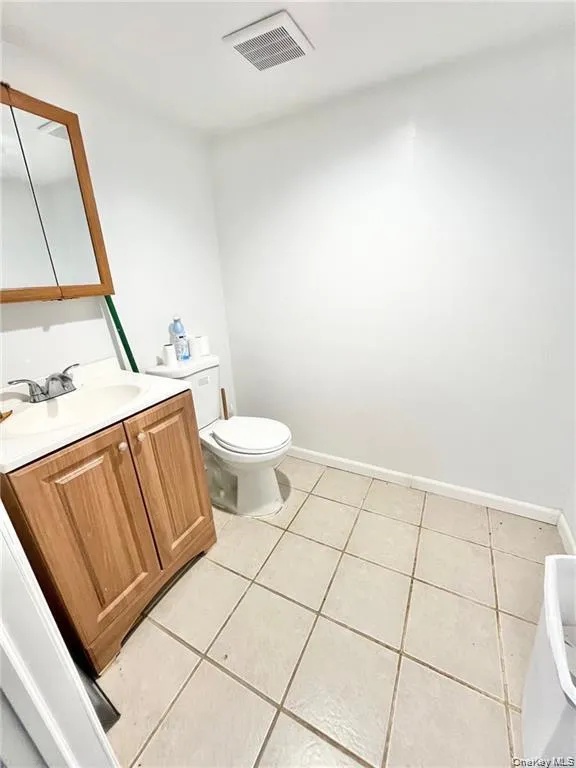Bathroom with vanity and light tile patterned floors Bathroom with vanity and light tile patterned floors