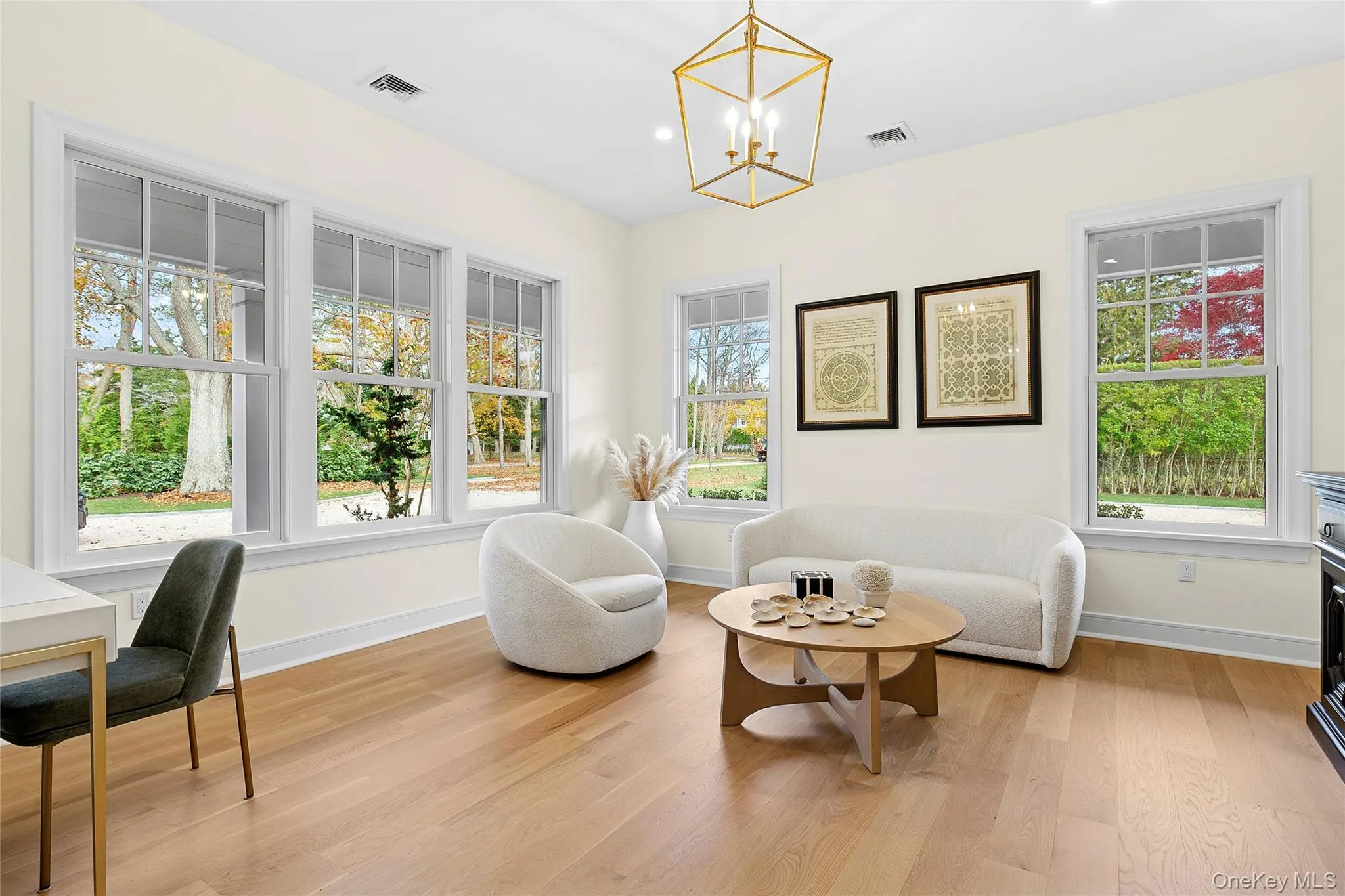 Living area with light wood-style flooring, a chandelier, and recessed lighting Living area with light wood-style flooring, a chandelier, and recessed lighting
