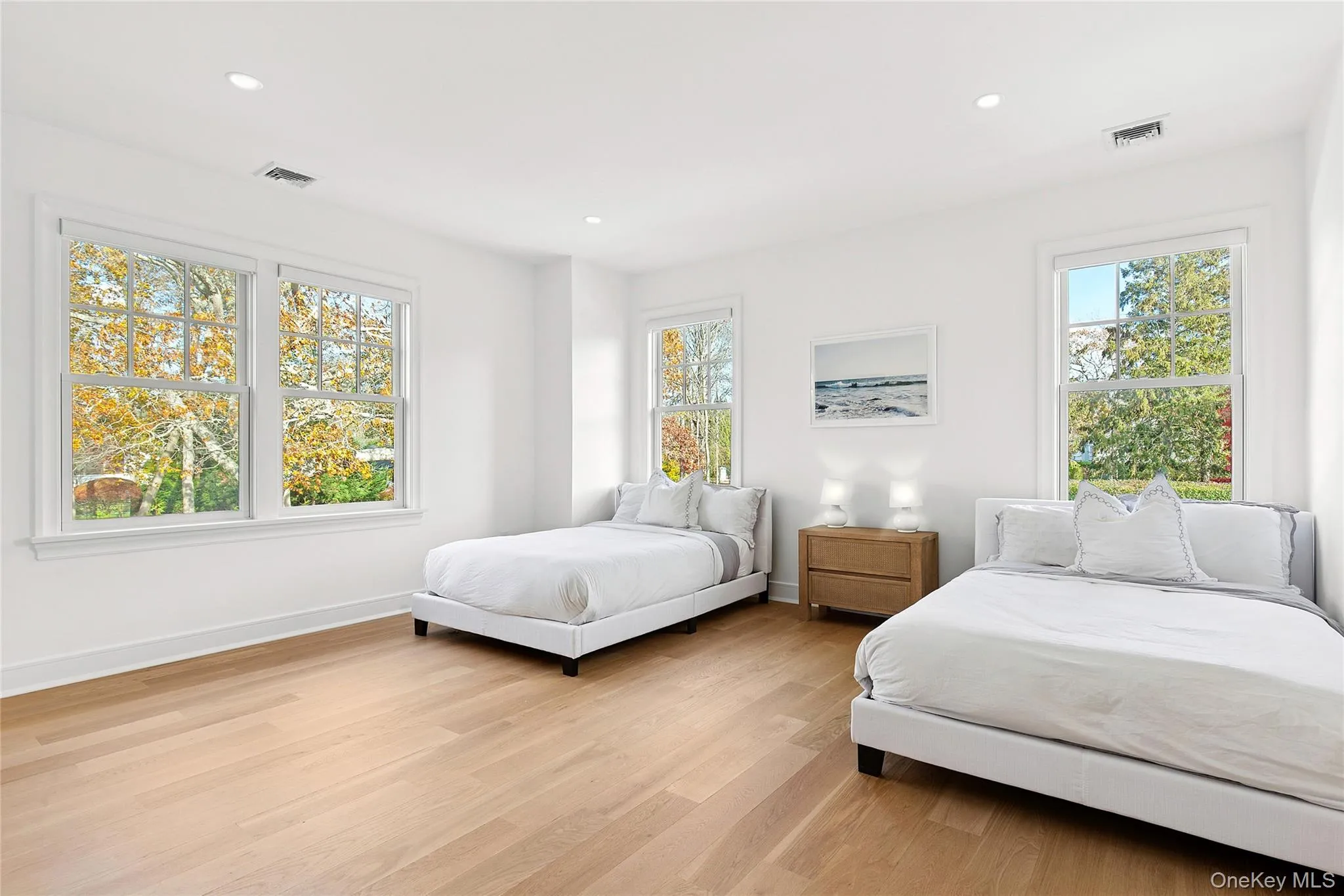Bedroom with light wood-type flooring and recessed lighting Bedroom with light wood-type flooring and recessed lighting