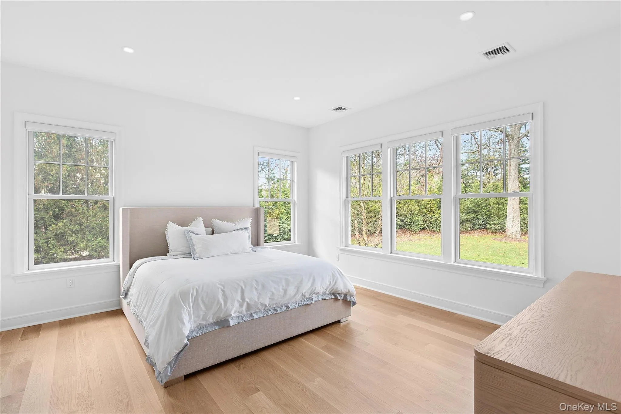 Bedroom featuring recessed lighting and light wood finished floors Bedroom featuring recessed lighting and light wood finished floors
