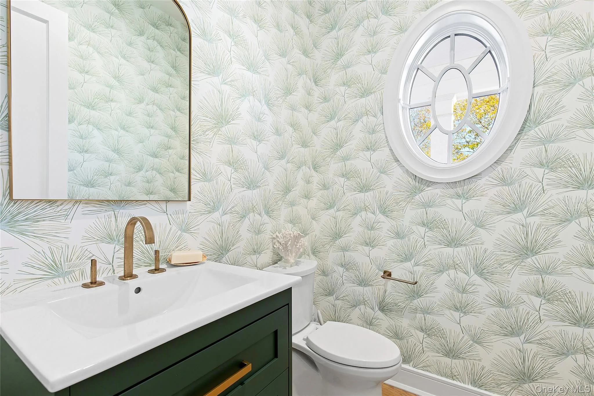 Bathroom featuring vanity and wallpapered walls Bathroom featuring vanity and wallpapered walls