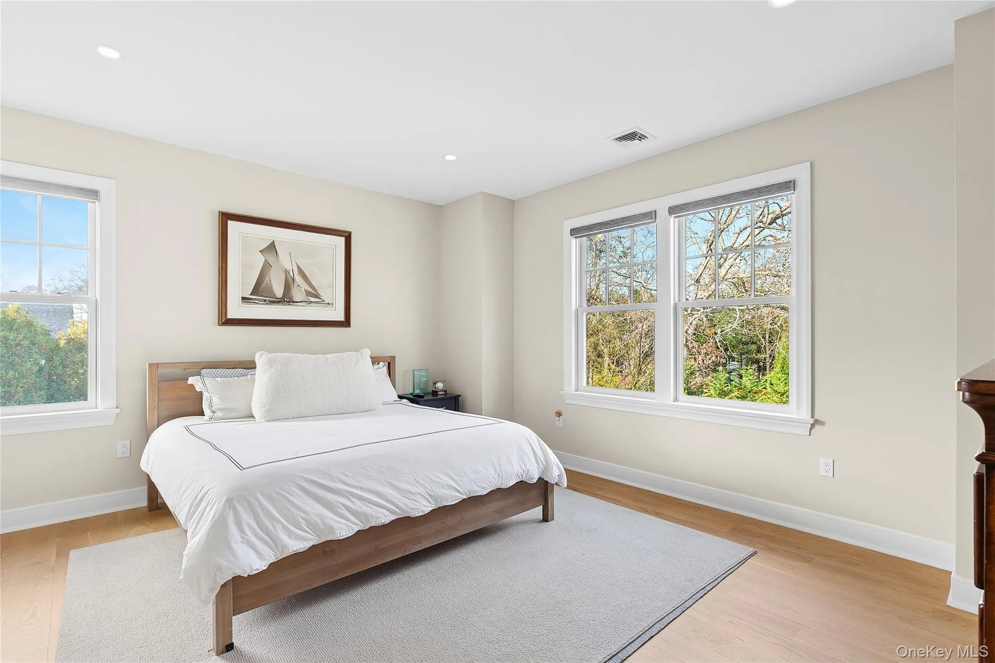 Bedroom featuring light wood-style floors and recessed lighting Bedroom featuring light wood-style floors and recessed lighting