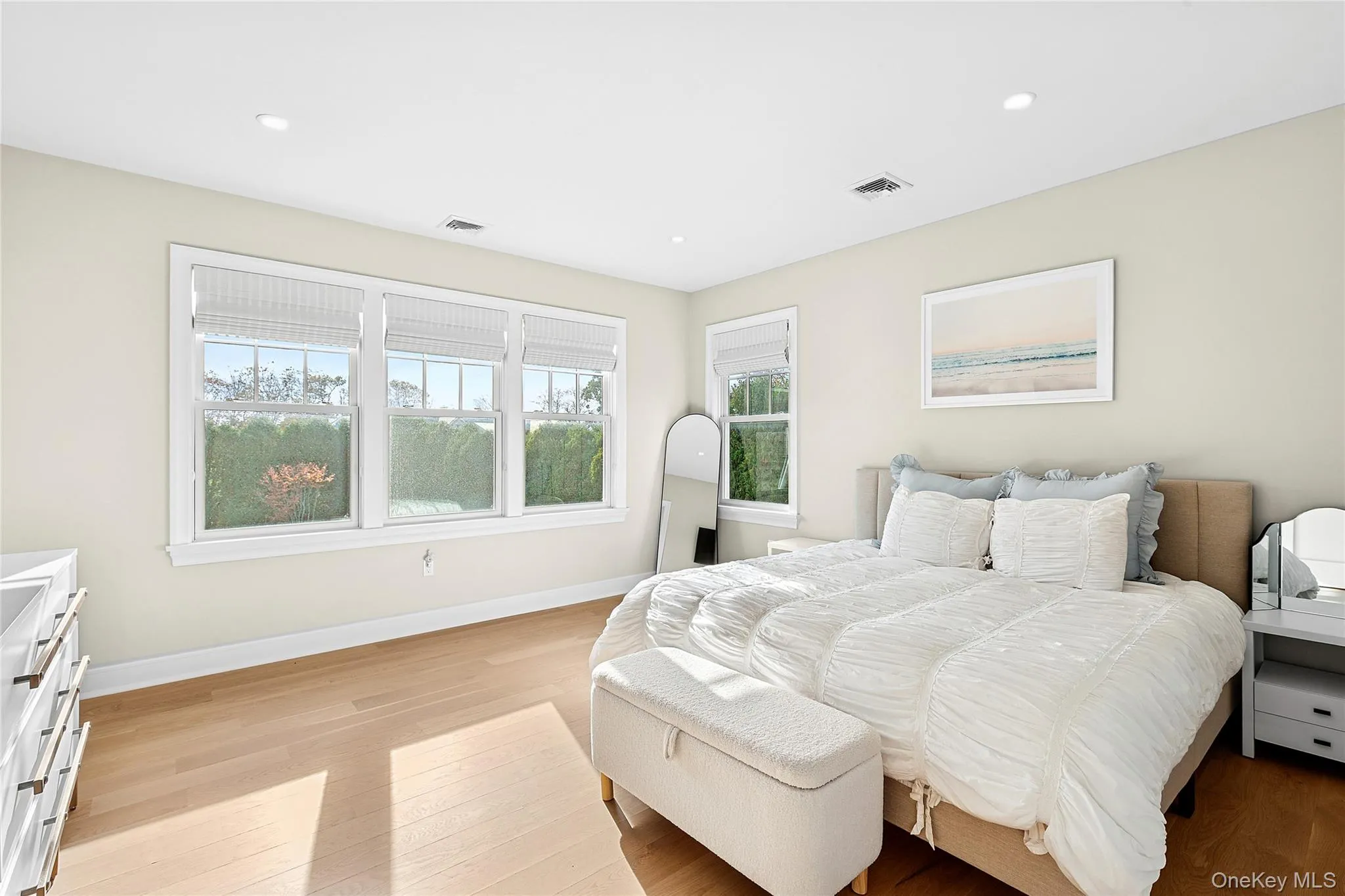 Bedroom with light wood-style floors and recessed lighting Bedroom with light wood-style floors and recessed lighting