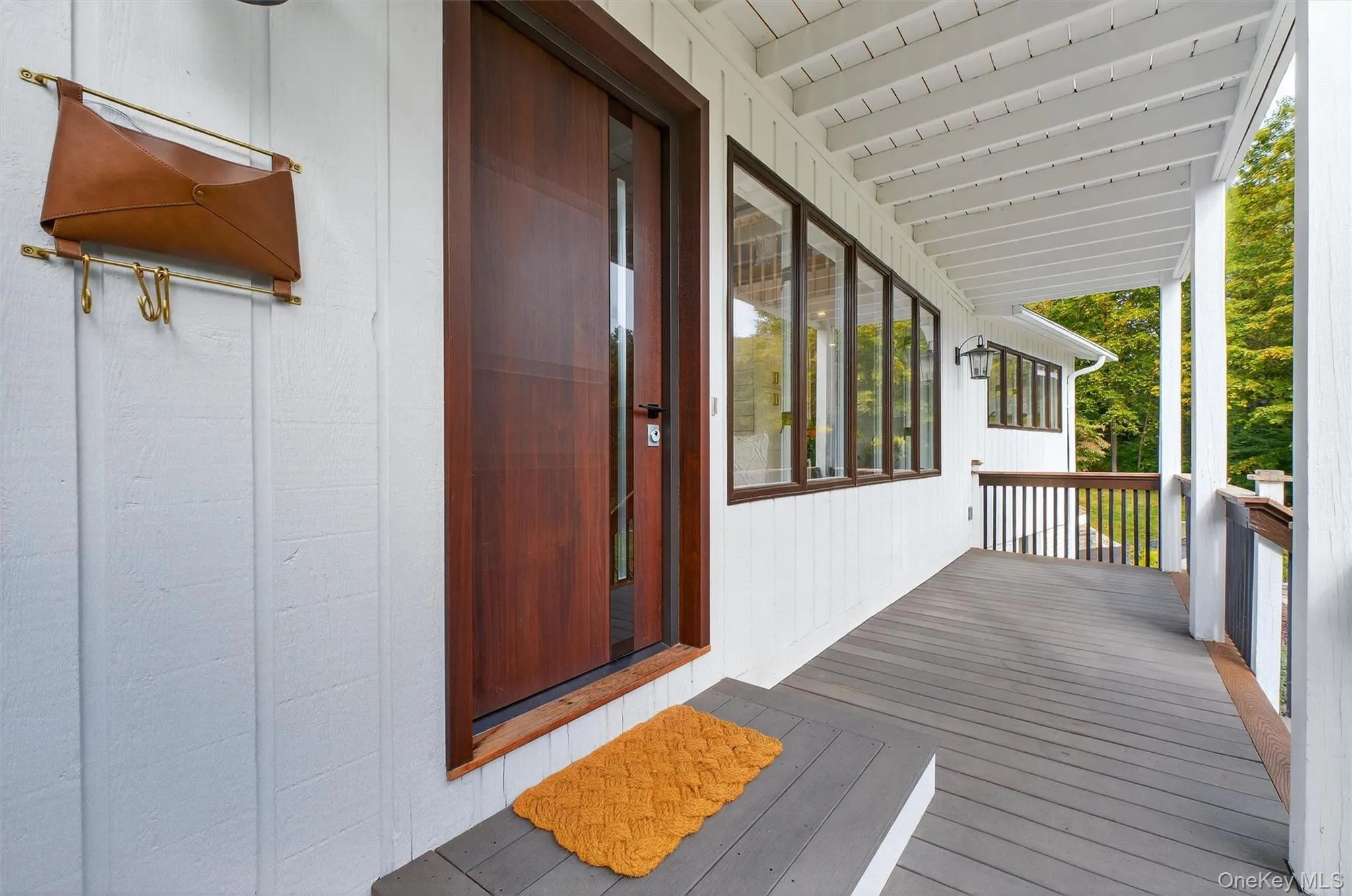 View of front porch with beautiful wood door View of front porch with beautiful wood door