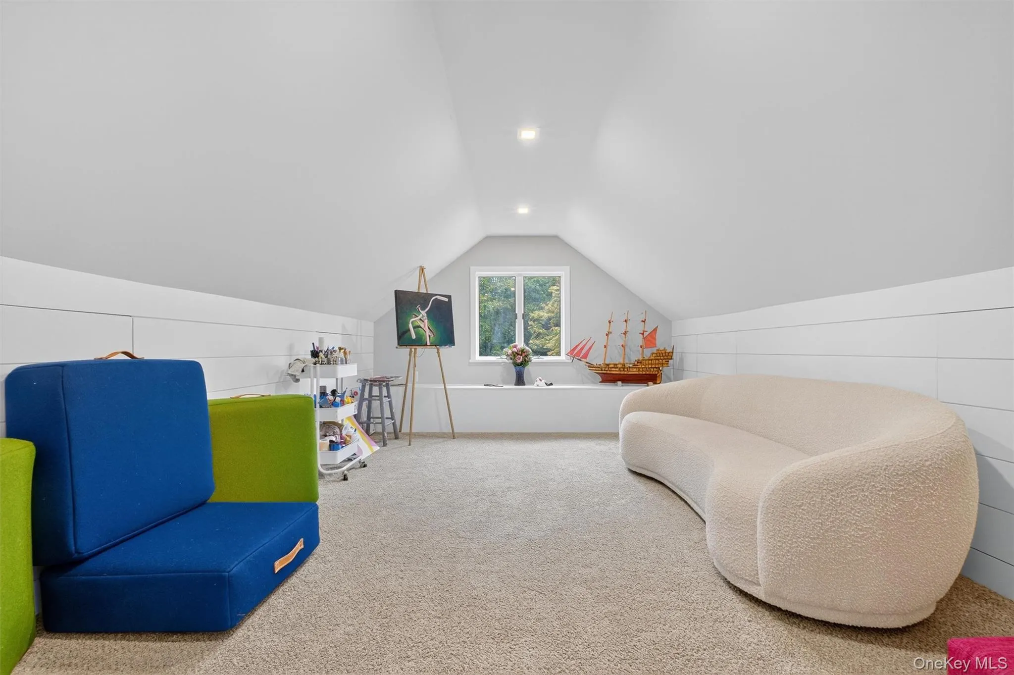 Sitting room with carpet flooring, lofted ceiling, and recessed lighting Sitting room with carpet flooring, lofted ceiling, and recessed lighting