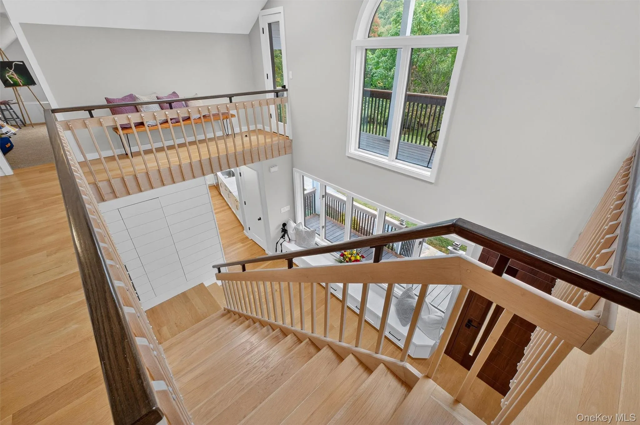 Stairs featuring wood  floors and high vaulted ceiling Stairs featuring wood  floors and high vaulted ceiling