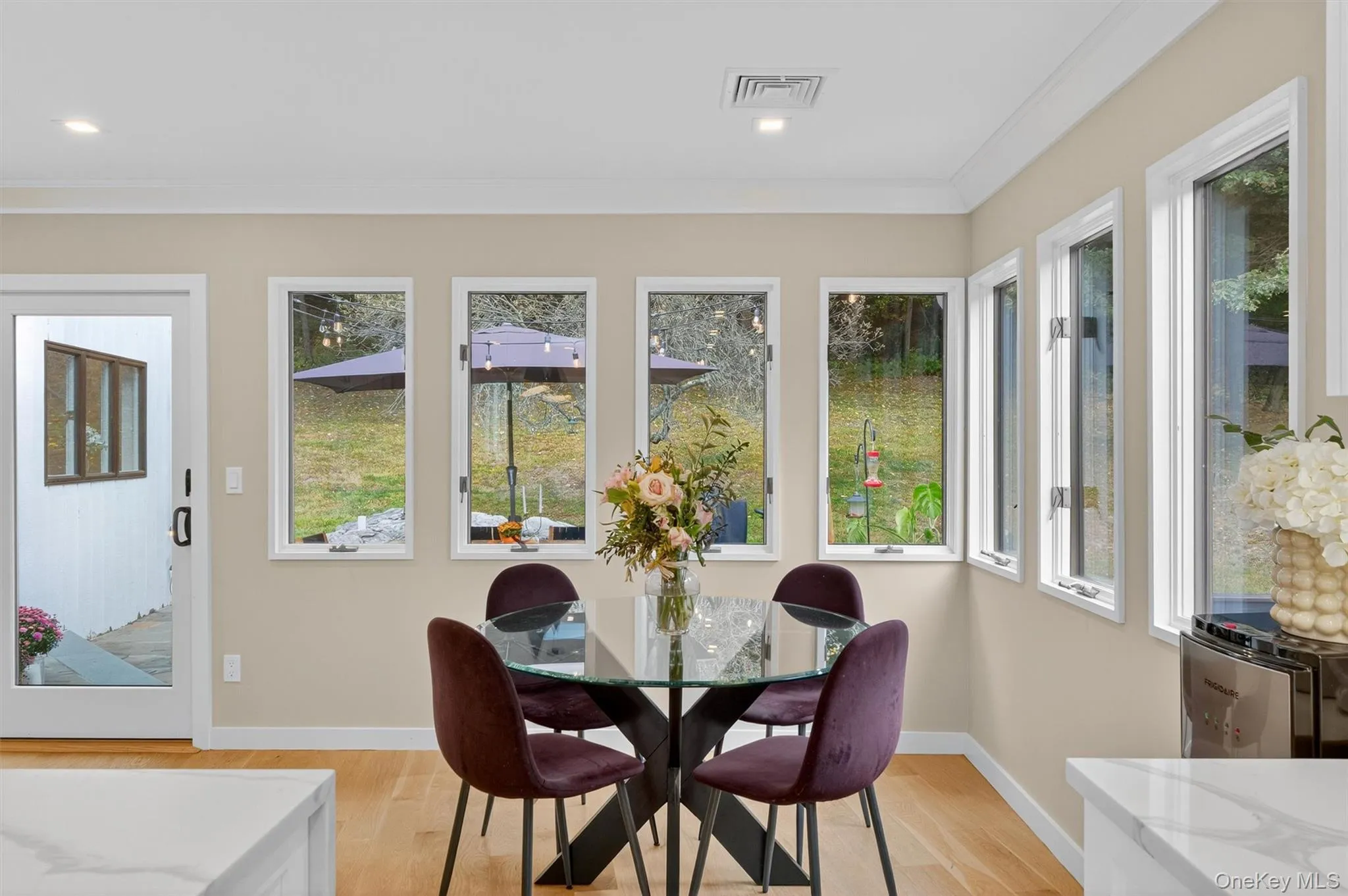 Eat-in kitchen area with wood floors, ornamental molding, and recessed lighting Eat-in kitchen area with wood floors, ornamental molding, and recessed lighting