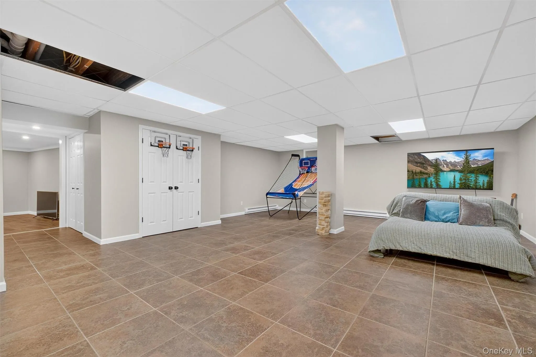 Full, finished game room in basement with tile floor Full, finished game room in basement with tile floor