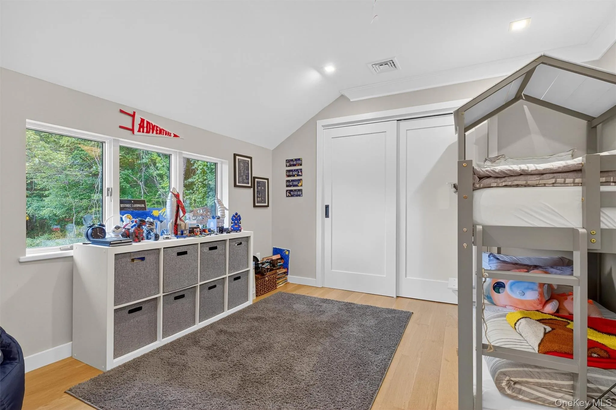 Bedroom featuring light wood flooring, vaulted ceiling, a closet, and recessed lighting Bedroom featuring light wood flooring, vaulted ceiling, a closet, and recessed lighting